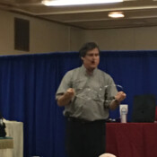 Marty G performing magic trick with three large metal rings.