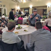 Wedding dinner reception with Marty G one of several tables performing magic for two men.